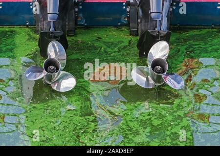 Zwei Schiffspropeller des Schnellbootes vor dem Hintergrund des grün aufblühenden Wassers Stockfoto