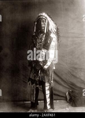 1907, USA: Der amerikanische Native CHIEF Jack Red Cloud of Oglala Lakota ( Sioux ) (* um 1822 in New York; † um 1909 in London). Foto von Edward S. CURTIS (* ca. - CAPO NUVOLA ROSSA - Der nordamerikanische Inder - GESCHICHTE - Foto Storiche - Warbonnet - Foto storica - Indianer - INDIANI D' AMERICA - PELLEROSSA - ureinwohner amerikaner - Indianer Nordamerikas - CAPO TRIBU' INDIANO - GUERRIERO - KRIEGER - Porträt - Ritratto - SELVAGGIO WEST - Piuma - Piume - Federn - STOCK - Halskette - Collana - Fransen - Frangie - Frangie © Archivio GBB / Stockfoto