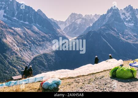 Gleitschirmfliegen in den Hochbergen der französischen Haute Savoie. Gleitschirmflieger machen sich bereit zum Start. Stockfoto