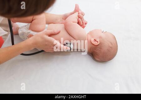 Kinderarzt hört auf Neugeborene. Körperliche Untersuchung eines kleinen Kindes Stockfoto