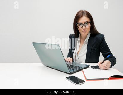 Geschäftsfrau mit Einstellung, die die Kamera im Büro betrachtet Stockfoto