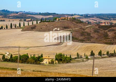 Landschaft auf der Crete Senesi mit Häusern auf Hügeln Stockfoto