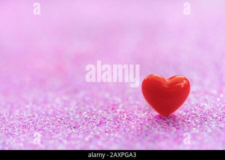 Valentines Day Hintergrund mit Red Heart Shapes auf abstraktem hellrosa Glitzerhintergrund, Copy Space Stockfoto