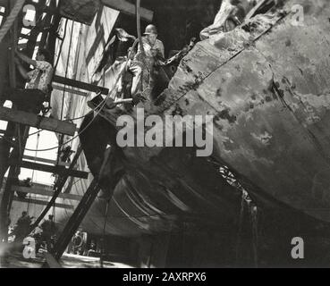 Arbeiter arbeiten an der Reparatur von Schäden an der USS North Carolina, die durch einen IJN Long Lance Torpedo verursacht wurden, der am 15. September 1942 von U-Boot I-19 abgefeuert wurde. Die Messgröße der Bohrung Stockfoto