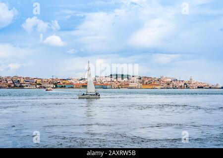 Segelboot Fahrt in Richtung Altstadt von Lissabon an der Flussmünde des Tejo in Lissabon, Portugal Stockfoto