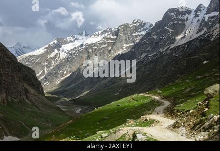 Ein Hirte, der auf einer Bergstraße spazieren geht Stockfoto