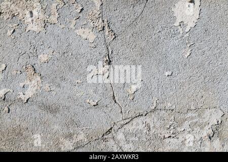 Alte, gerissene Wandoberfläche. Nahaufnahme an einer verputzten Wand. Stockfoto