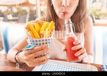 Mädchen im Straßencafé isst leckere und saftige Gyros mit Pita. Konzept der mittelöstlichen Küche Stockfoto