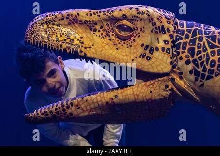 Kinder der Stockwell Primary School treffen lebensähnliche Dinosaurier-Marionetten, die derzeit im Erth's Dinosaur Zoo im Southbank Center, London, Großbritannien, erscheinen. Stockfoto