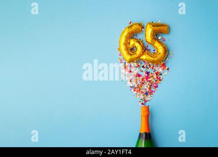 65. Jahrestag Champagner Flasche Ballon Pop Stockfoto