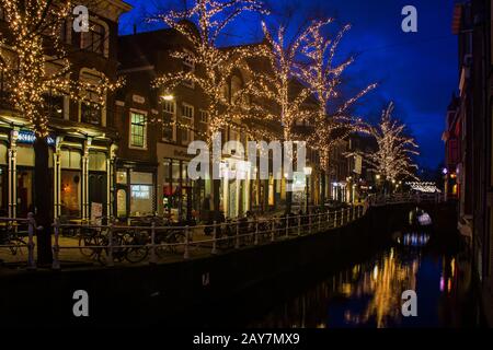 Delft, Niederlande, Holland, 18. Januar 2020. Blick auf den Kanal und die Straße, die traditionellen Häuser und die geparkten Fahrräder in der Altstadt. Stockfoto