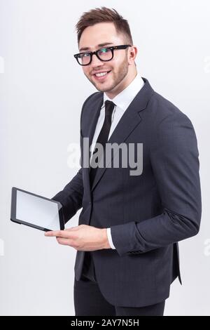 Ein Bild von einem ernsthaften Unternehmer, der mit einem Tablet steht Stockfoto
