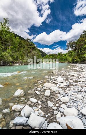 Kalter Wasserstrom in den Alpen am sonnigen Tag Stockfoto