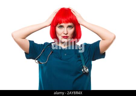 Attraktive lustig smilling kaukasischen brunette Ärztin in Rot Perücke in Office täuschen Stockfoto