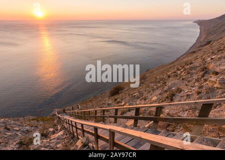 Leiter hinunter zum Meer auf einem felsigen Klippe, Sonnenuntergang, Sochi, Russland Stockfoto