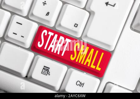 Handwriting text writing Start Small. Concept meaning Small medium enterprises start up Business entrepreneurship White pc keybo Stockfoto