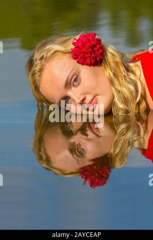 Portrait-Spiegelbild blonde Frau im Wasser Stockfoto