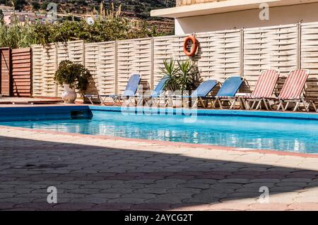 Kleiner rechteckiger Pool mit Liegestühlen in einem Hotel Stockfoto