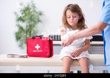 Kleines Mädchen besuchen alte Frau Doktor Stockfoto