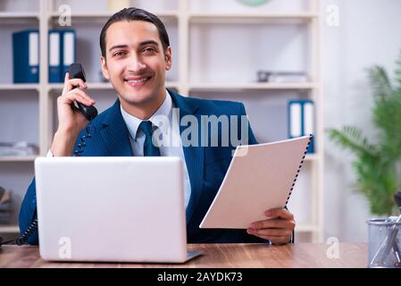 Junge gut aussehender Geschäftsmann die Arbeit im Büro Stockfoto