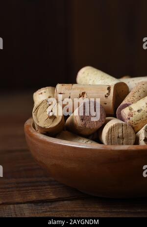 Nahaufnahme einer Holzschale voller gebrauchtem Weinkorken. Vertikal mit Kopierbereich. Stockfoto
