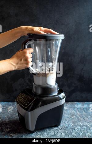 Einen gesunden Smoothie auf einem Mixer zubereiten. Stockfoto