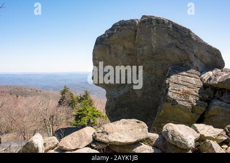 Große Felsbrocken sind der perfekte Ort für aufmerksame Besucher, um die scheinbar endlosen Aussichten am Grandfather Mountain in Linville, NC, zu fotografieren. Stockfoto