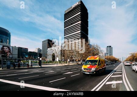 Madrid, Spanien - 15. Februar 2020: Blick auf den Passeo de la Castellana, einen breiten Boulevard im Zentrum von Madrid. Der Krankenwagen passiert die Szene Stockfoto