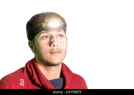 Wanderer mit Stirnlampen-Taschenlampe mit Lichtstrahl isoliert auf weiß Stockfoto