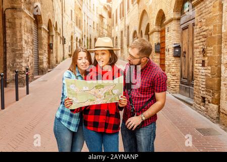 Mehrere Rassen Gruppe von Freunden Touristen, die Karte in einer alten Stadt in Italien suchen. Reise- und Abenteuerkonzept Stockfoto