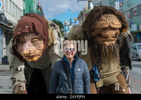 Frau (Modellversion 20020923-10) posiert mit Trollen im Stadtzentrum von Akureyri, Nordisland. Stockfoto