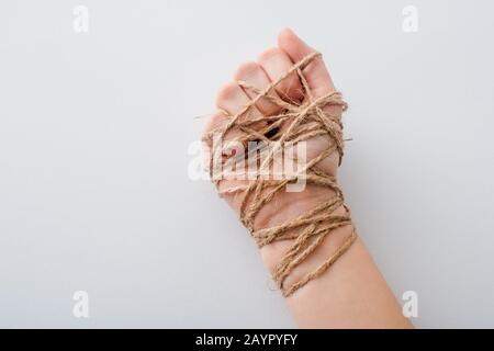 3/4-Ansicht des Mädchens mit gebundener Hand isoliert auf weißem Menschenrechtskonzept Stockfoto