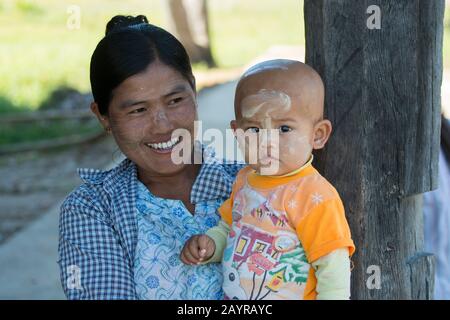 Porträt einer Mutter mit Kind mit Paste aus dem Thanaka-Baum auf ihrem Gesicht, die Schutz vor Sonnenbrand im Dorf Kuwoo auf Inle bietet Stockfoto