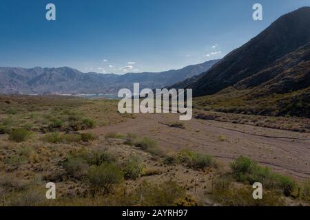 Landschaft des Flusses Cacheuta, mit Berg- und Proterillos-Staudamm im Hintergrund in Mendoza, Argentinien Stockfoto