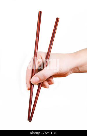 Japanische Bambusstäbchen in weiblicher Hand Stockfoto