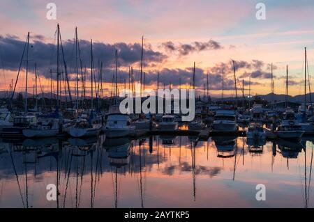 Farbenfroher Sonnenuntergang über Coffs Harbour Marina mit Yachten und Booten. Australische Reiseziellandschaft Stockfoto