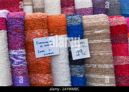 Traditionelle Teppiche, die im Februar im Laden in Pampaneira, Andalucia, Spanien, hängen - örtlich angefertigtes Kunsthandwerk Stockfoto