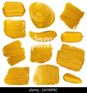Goldene Malpinsel streicht Schmugdeset. Goldene Metallfolie farblackierte Designelemente sind auf weißem Hintergrund isoliert. Stockfoto