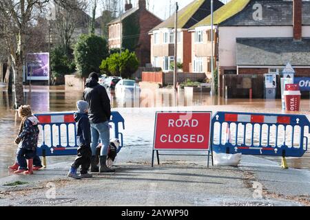 Hereford, Herefordshire, Großbritannien - Montag, 17. Februar 2020 - EINE junge Familie hält an, um das Hochwasser entlang des Ledbury Road Bereichs der Stadt zu sehen, zu dem eine überflutete Texaco-Tankstelle gehört. Foto Steven May / Alamy Live News Stockfoto