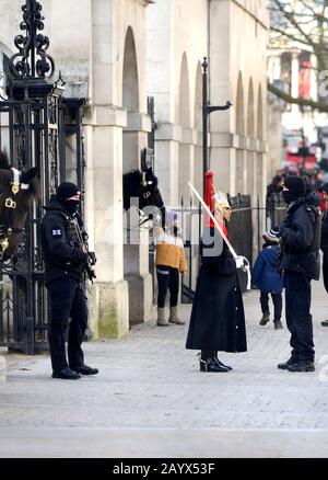 London, England, Großbritannien. Mitglied der Blues and Royals mit bewaffneter Polizei in Whitehall Outside Horse Guards Parade Stockfoto