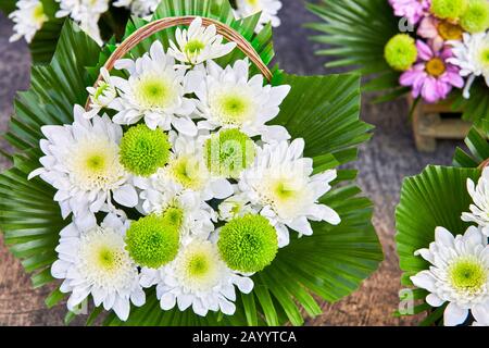 Nahansicht eines Blumenstraußes mit leuchtend weißen und grünen Blumen, schön in einem Korb angeordnet, umgeben von farbenfrohen und rosafarbenen Blumen, Asien Stockfoto