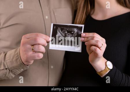 Schwangerschaft, schwangere Frau, kleine Erschießung, warten auf ein Kind, schwarzes Kleid, schwanger, warten auf ein Wunder, Bild eines schwangeren Mädchens, Snapsho Stockfoto