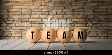 Bälle mit dem WORTTEAM vor einer Ziegelwand - 3D gerenderte Illustration Stockfoto