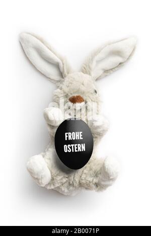 Gefüllte Brötchen mit der Nachricht "Hapy Easter" auf Deutsch auf weißem Hintergrund Stockfoto