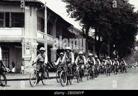 Vietnam: Kaiserliche japanische Armee Truppen radeln durch Saigon, c. 1942. Die japanische Invasion der französischen Indochina, auch als Vietnam-Expedition bekannt, war eine Bewegung des japanischen Imperiums im September 1940, während des Zweiten Chinesisch-Japanischen Krieges, um China daran zu hindern, Waffen und Treibstoff durch die französische Indochina zu importieren, Über die chinesisch-vietnamesische Eisenbahn vom Hafen Haiphong über Hanoi nach Kunming in Yunnan. Japan besetzte Nord-Indochina, was die Blockade Chinas verschärfte und die Fortsetzung der langwierten Schlacht von Süd-Guangxi überflüssig machte. Stockfoto