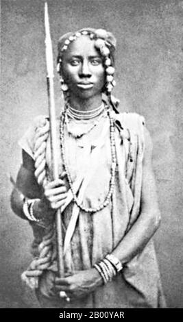Benin/Dahomey: Ein Mitglied der Mino oder 'Dahomey Amazons' , c. 1890. Die Dahomey Amazonen oder Mino waren ein Fon all-female Militärregiment des Königreichs Dahomey (heute Benin), das bis zum Ende des 19th. Jahrhunderts dauerte. Die Mino wurden aus den Ahosi ("Königsfrauen") rekrutiert, von denen es oft Hunderte gab. Einige Frauen in der Fon-Gesellschaft wurden freiwillig ahosi, während andere unfreiwillig eingeschrieben wurden, wenn ihre Ehemänner oder Väter sich beim König über ihr Verhalten beschwerten. Die Mitgliedschaft bei den Mino sollte alle aggressiven Charaktereigenschaften zum Zwecke des Krieges schärfen. Stockfoto