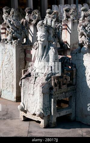 Thailand: Chinesische Figur im Haupttempelkomplex, Wat Arun (Tempel der Morgenröte), Bangkok. Wat Arun Rajwararam (Tempel der Morgenröte), voller Name Wat Arunratchawararam Ratchaworamahawihan, ist ein thailändischer buddhistischer Tempel am Thonburi-Westufer des Chao Phraya-Flusses in Bangkok. Es ist nach Aruna, dem indischen Gott der Morgenröte, benannt. Seit der Ayutthayan-Zeit (1351 - 1767) steht hier ein Kloster, aber das herausragende Merkmal des Tempels, der zentrale Prang im Khmer-Stil, wurde erst 1809, während der Herrschaft von König Buddha Loetla Nabhalai (Rama II), begonnen. Stockfoto