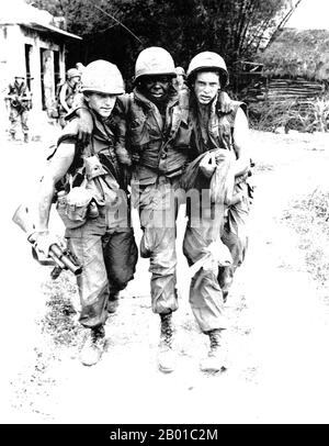 Vietnam: Zwei Soldaten der US-Armee helfen einem verwundeten Kameraden in My Lai. Foto von Ronald L. Haeberle (gemeinfrei), März 6 1968. US-Soldaten, die am Massaker von My Lai oder Thảm sát Mỹ Lai (6. März 1868) in Zentralvietnam beteiligt waren, als 347 bis 504 unbewaffnete vietnamesische Zivilisten von einer Einheit US-Truppen unter dem Kommando von Vizeleutnant William Calley massakriert wurden. Stockfoto