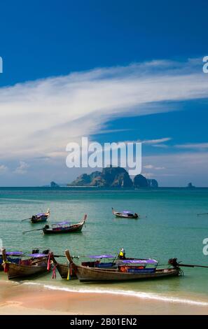 Thailand: Tourboote in Ao Nang, Krabi Coast. AO Nang, eine wunderschöne Bucht und Strand, liegt westlich der Phra Nang Halbinsel, aber durch eine felsige Landzunge von Ao Ton Sai getrennt. Vielleicht weil es von Krabi aus leicht mit dem Auto zu erreichen ist, ist es extrem beliebt und wahrscheinlich ist es in der Hochsaison geschäftig. Die meisten Touristen aus Übersee sind Europäer, viele aus den skandinavischen Ländern. Die Provinz Krabi besteht aus mehr als 5.000 km2 Dschungelhügeln und scharfen, zerklüfteten Karstvorsprüngen sowie mehr als 100 km üppiger, unberührter Küste und rund 200 Inseln. Stockfoto