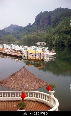 China: Fluss Jin am Eingang zu Danxiashan (Mount Danxia), nördlich von Shaoguan, Provinz Guangdong. Der Danxia Mountain, was Red Rosy Clouds Mountain bedeutet, ist eine berühmte malerische Gegend in der Nähe der Stadt Shaoguan im nördlichen Teil der Provinz Guangdong. Das Gebiet besteht aus einem rötlichen Sandstein, der im Laufe der Zeit zu einer Reihe von Bergen erodiert wurde, umgeben von kurvigen Klippen und vielen ungewöhnlichen Felsformationen (Danxia Landform). Es gibt eine Reihe von Tempeln in den Bergen und viele schöne Spaziergänge. Es gibt auch einen Fluss, der sich durch die Berge schlängelt, auf dem Bootsausflüge gemacht werden können. Stockfoto